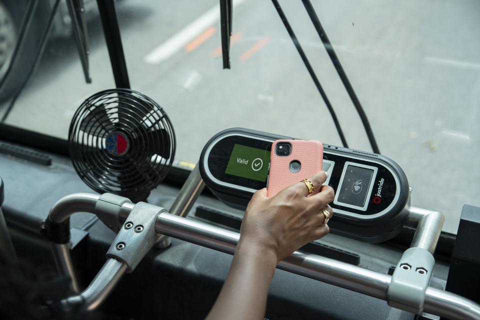 A hand scanning a phone screen on the validator.
